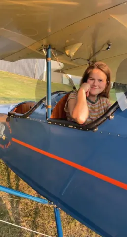 Passenger seated in a blue aircraft cockpit