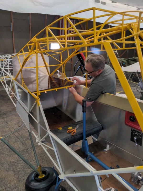 Fabric work on an aircraft fuselage frame
