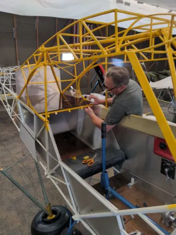 Fabric work on an aircraft fuselage frame