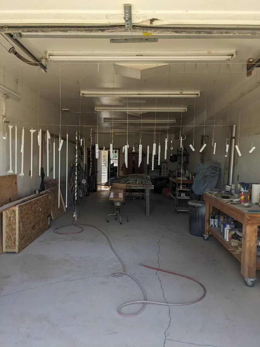 Aircraft parts hanging in a paint booth