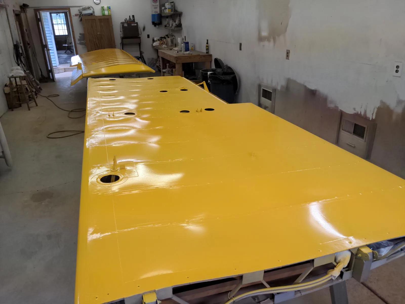 Yellow aircraft wing in the shop