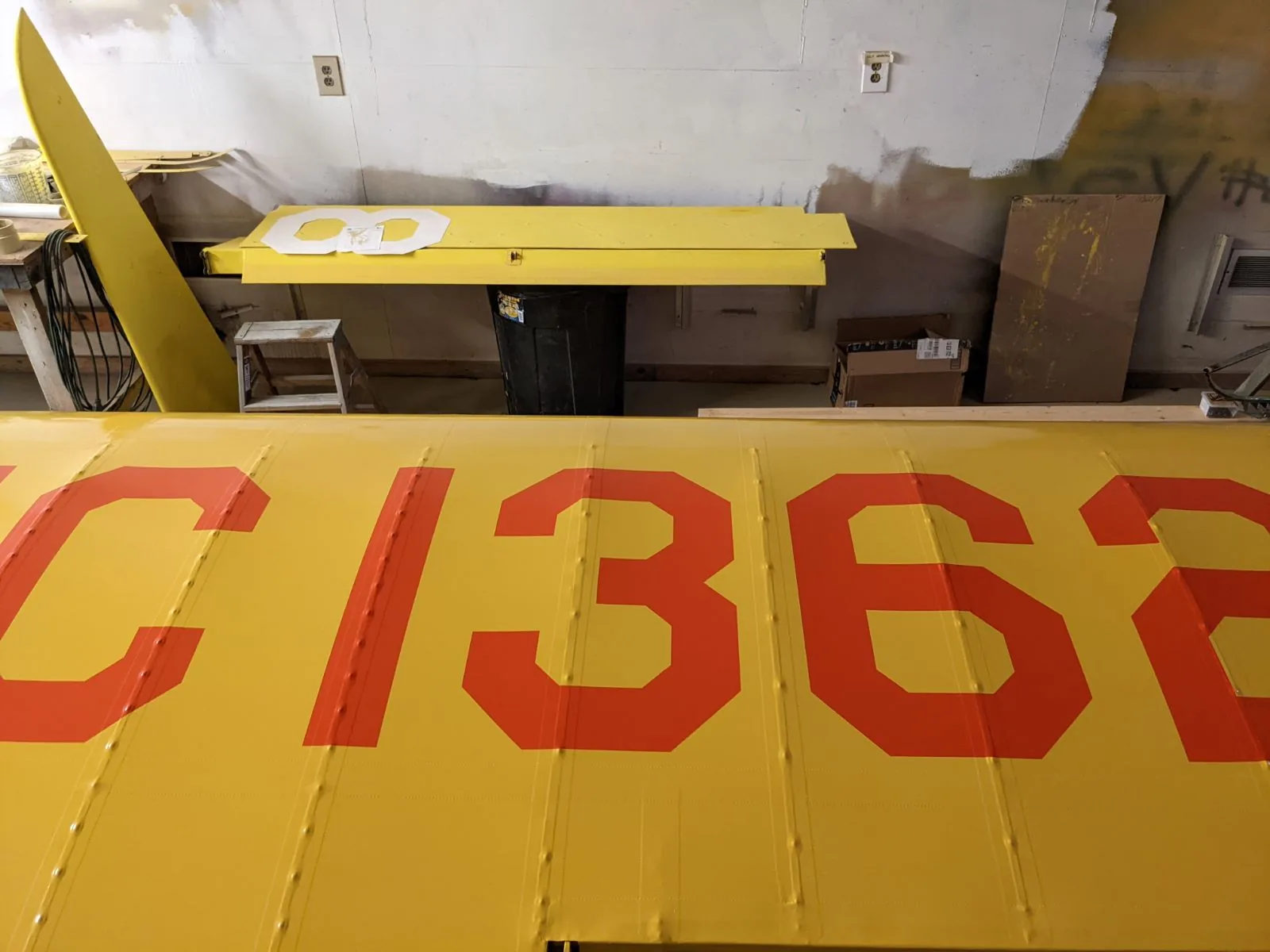 Yellow aircraft wing with registration letters